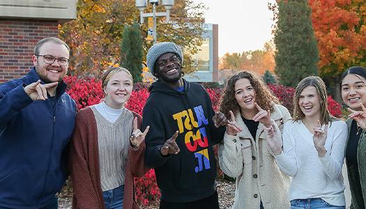 a group of students poses together for a photo outside